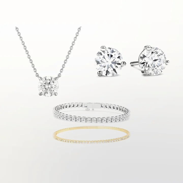 A solitaire pendant, stud earrings, a tennis bracelet and a flex bangle in lab-grown diamonds